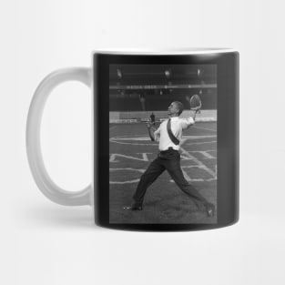 President Barack Obama throws a football Mug